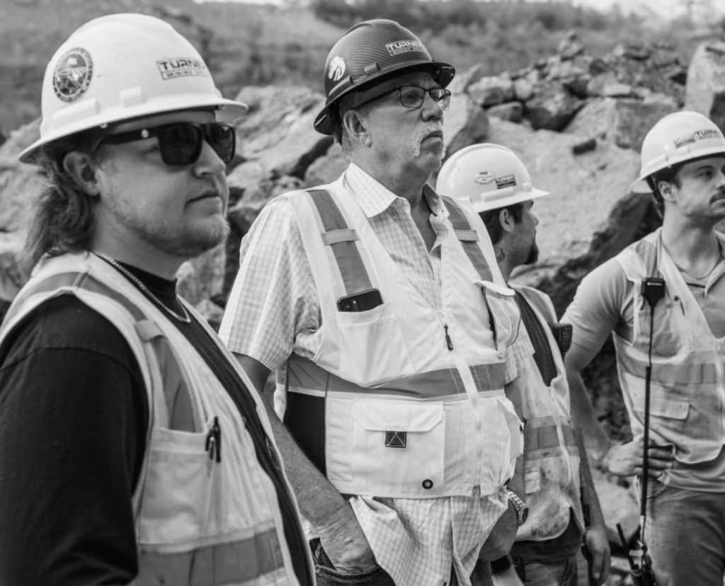Mining and construction employees in team meeting at job site