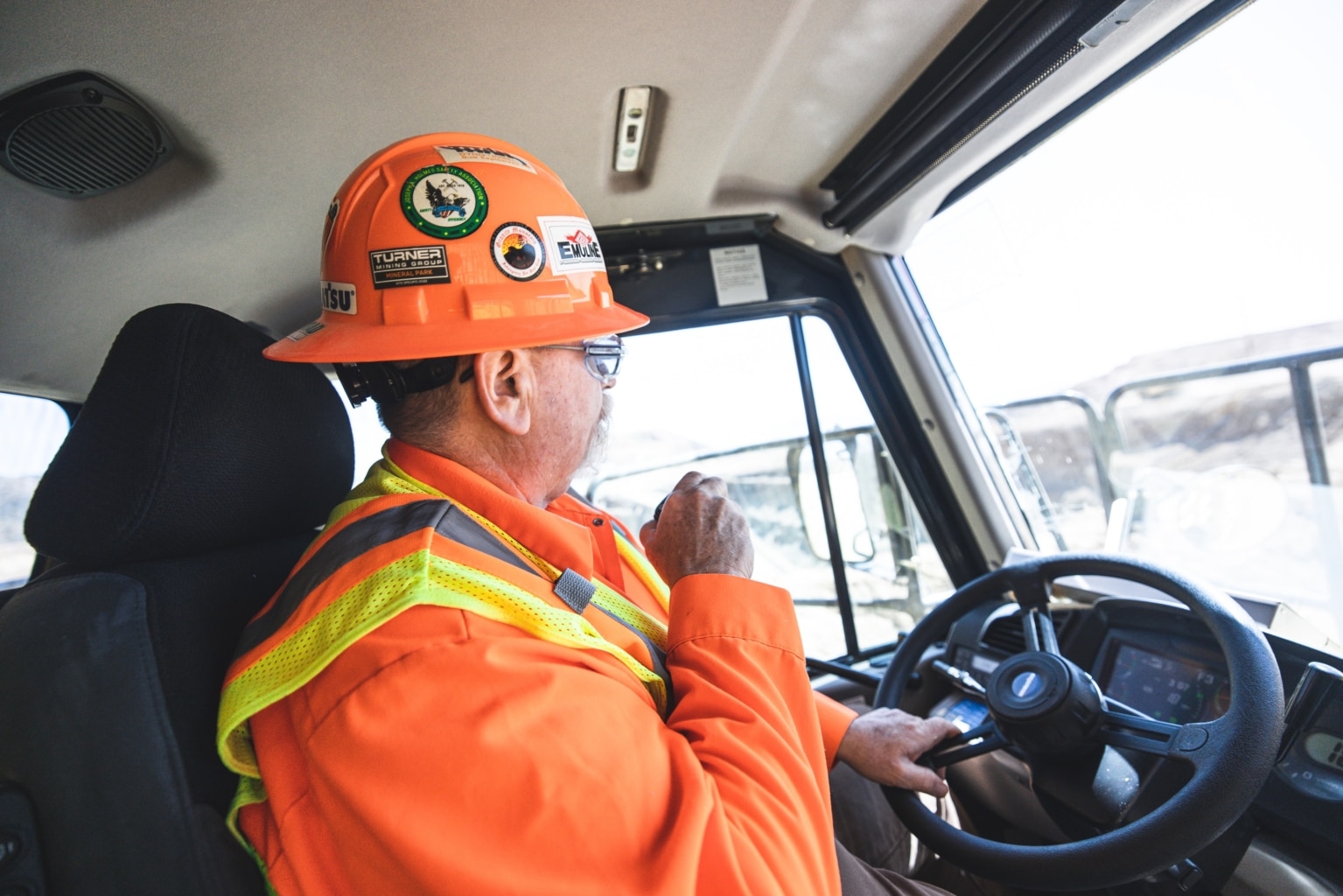 Construction worker sitting in cabin of a vehicle