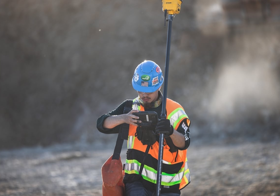 A surveyor at a construction site